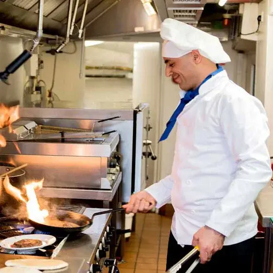 Southern Pines Chef Created Meals, chef frying a dish.