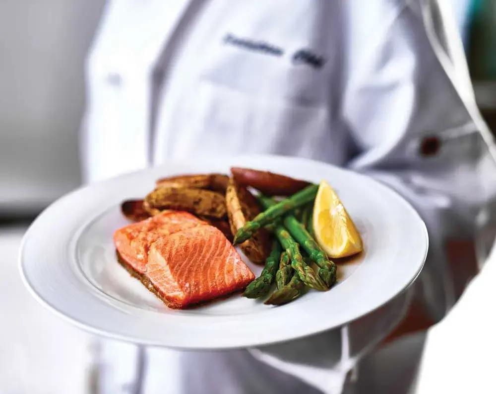 Southern Pines Chef Created Meals, chef delivering a finished dish.
