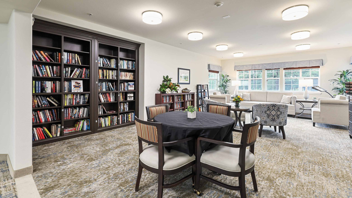 The library at Southern Pines with shelves of books and comfortable seating